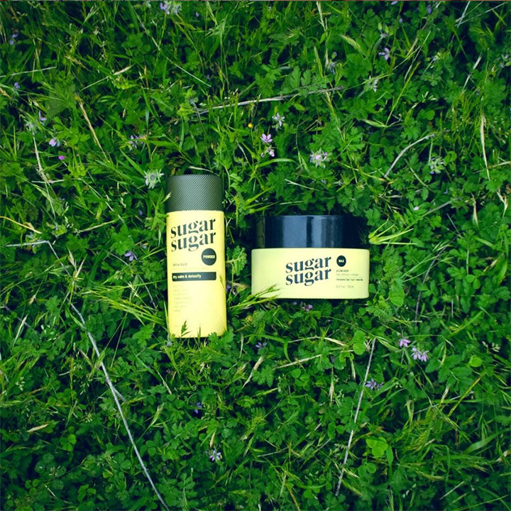 Glow Goop and Detox Dust products on grass.