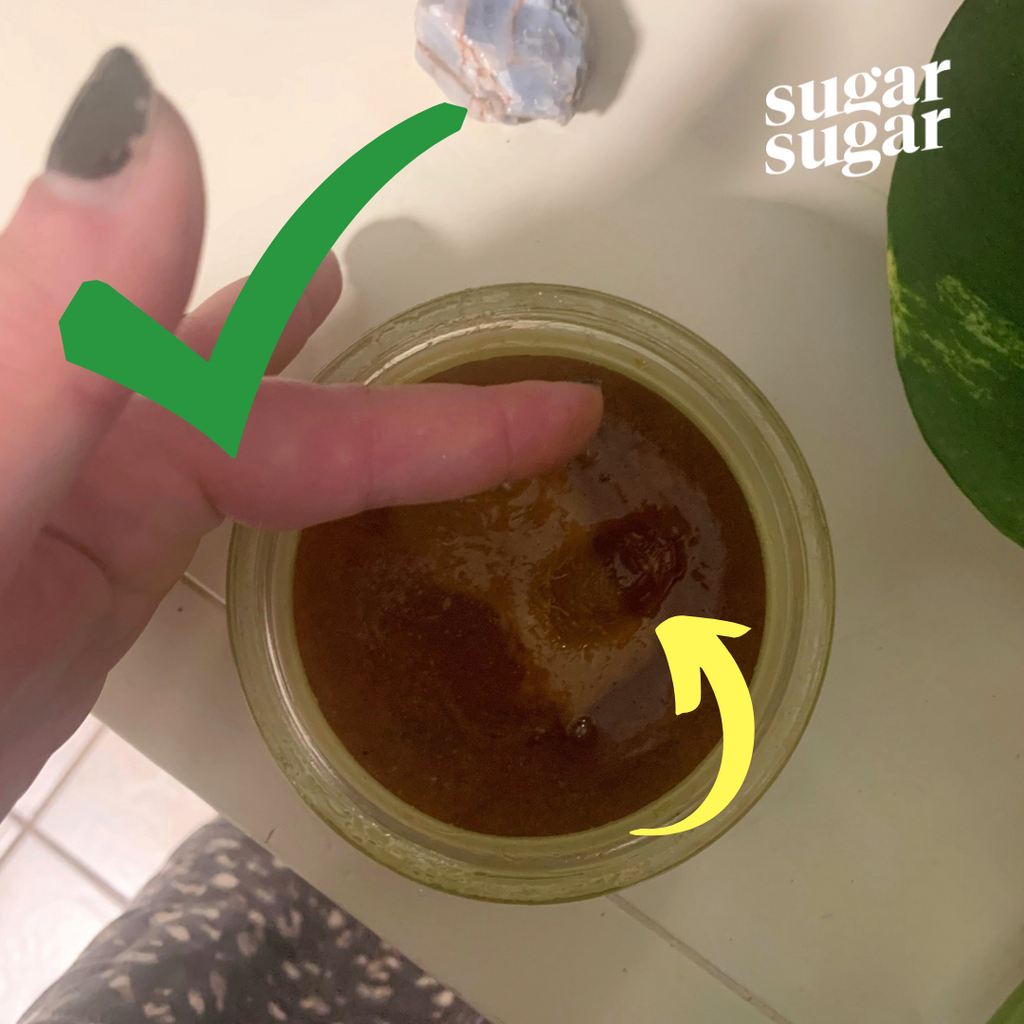 Good Glow Goop Sugar Wax consistency. Green check mark showing dent in the sugar wax
