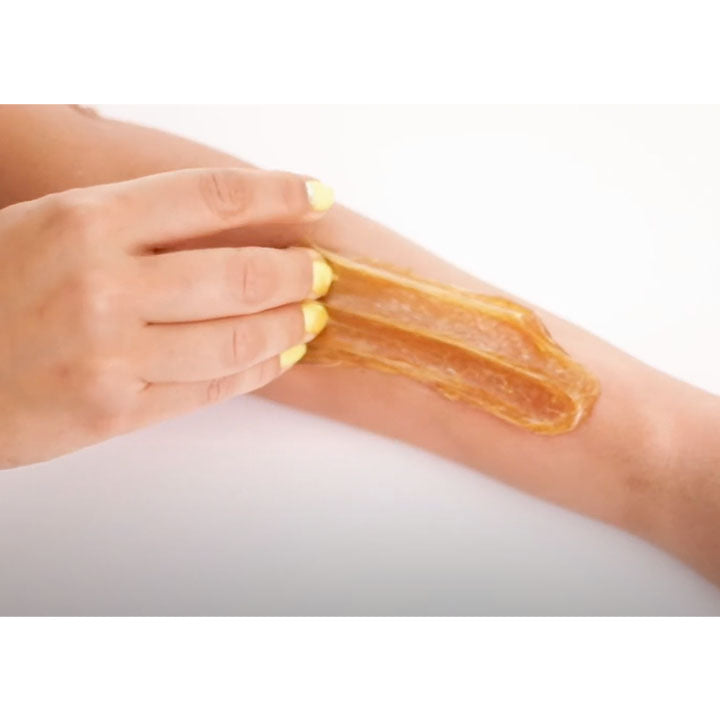 Applying sugaring wax to arm. Sugar Sugar Wax Glow Goop on arm.